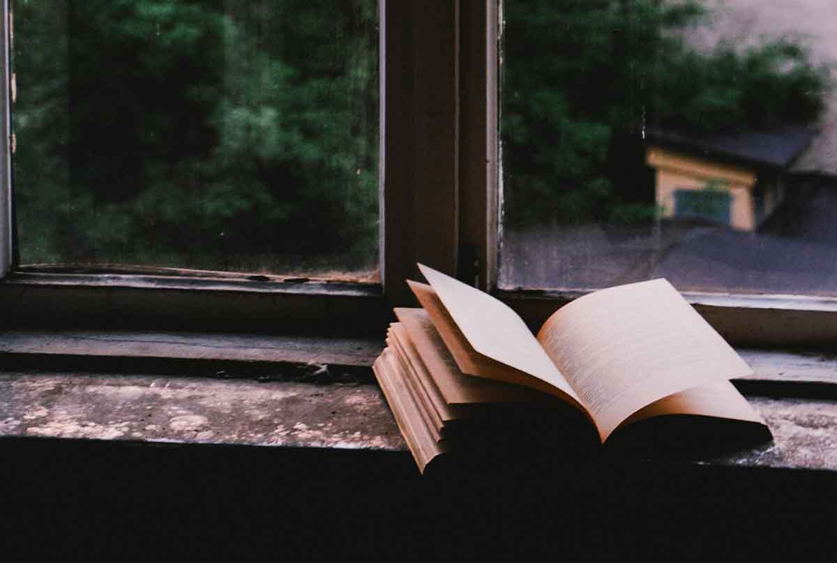 کتاب باز کنار پنجره