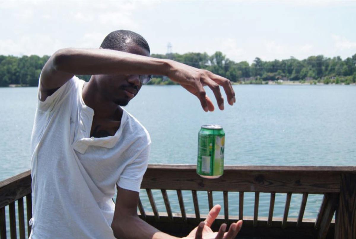 اقای سیاه پوستش که کنار دریاچه بطری را تو هوا نگه داشته