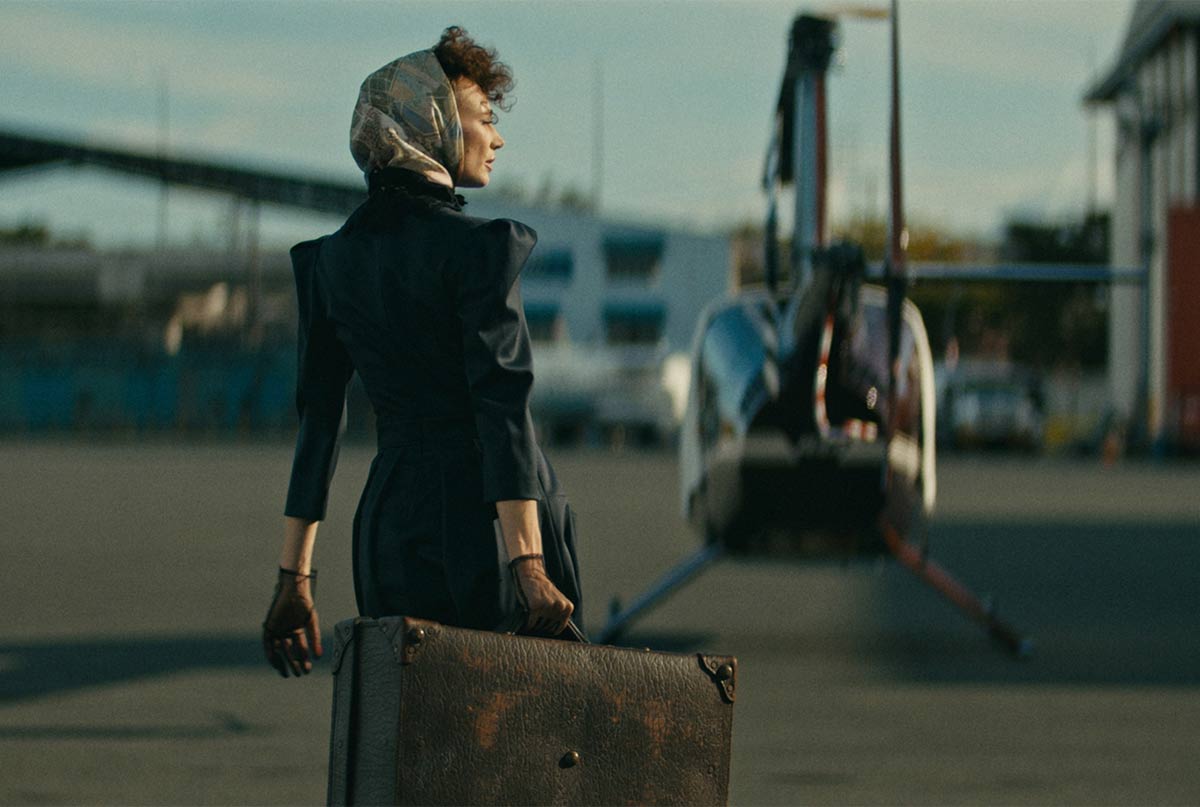 خانمی که روسرس سرشه و چمدون به دست تو فرودگاهه